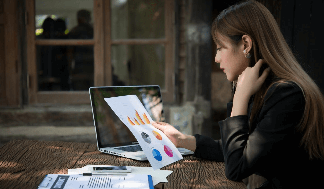 User analyzing marketing performance on a laptop using top analytics tools for 2025 with charts and real-time data insights.